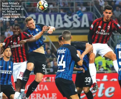  ?? Photo: AP ?? Inter Milan’s Milan Skriniar heads the ball as AC Milan’s Franck Kessie jumps beside him