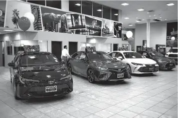  ?? Associated Press ?? ■ Toyota sedans are displayed Thursday in a showroom at Puente Hills Toyota in Industry, Calif. If 25 percent tariffs are fully assessed against imported parts and vehicles, and they include Canada and Mexico, the price of imported vehicles would rise more than 17 percent, or around $5,000 each, according to forecasts from IHS Markit. “I think it would be harmful to the whole economy,” said Howard Hakes, president of Hitchcock Automotive, which has three Toyota showrooms in metro Los Angeles.