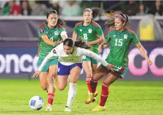 ?? ASSOCIATED PRESS ?? United States forward Sophia Smith, front, falls while vying for the ball against, from back left to right, Mexico defender Rebeca Bernal, midfielder Alexia Delgado and defender Cristina Ferral during Monday’s CONCACAF Gold Cup women’s soccer tournament match in Carson, Calif.