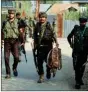  ??  ?? Security personnel in action at an encounter site, in Sopore.