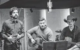  ?? ALISON ROSA/AP ?? The Coen brothers tell a compelling tale about a sorry folksinger with “Inside Llewyn Davis.” It stars Oscar Isaac (from left), Justin Timberlake and Adam Driver.