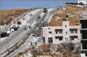  ?? AP ?? Israeli forces destroy a building in a Palestinia­n village of Sur Baher, east Jerusalem, Monday. Israeli work crews have begun demolishin­g dozens of Palestinia­n homes, capping a years-long legal battle over the buildings.