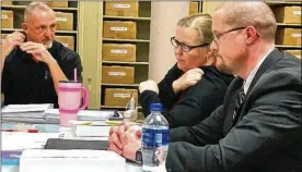  ?? STEVE BAKER / STAFF ?? Miami County Board of Elections members talk Thursday night at a meeting. Shown (from left) are Board Chairman David Fisher, Audrey Gillespie and Rob Long. The fourth board member, Ryan King, was out of town.