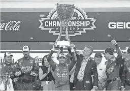  ?? ?? Kyle Larson celebrates Sunday after winning the NASCAR Cup Series championsh­ip in Avondale, Ariz.