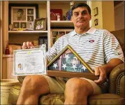  ?? NATE GETTLEMAN ?? Frank Ros, captain of the 1980 Georgia national title team, displays his U.S. citizenshi­p papers in 2017. Ros’ mother died last week in their native Spain.