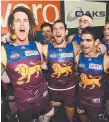  ??  ?? Luke Hodge (centre) leads the Lions’ victory song.