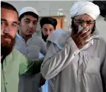  ?? AP, Reuters ?? Medics treat an injured person at a hospital in Peshawar. Right, people comfort a cleric at the seminary. —