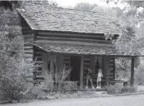  ?? STAFF FILE PHOTO ?? In this 2002 file photo, Reagan Hughes, left, and Hannah Queen visit the Spring Frog cabin at Audubon Acres in East Brainerd.