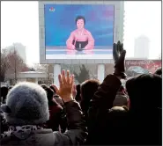  ?? AP/KIM KWANG HYON ?? North Koreans cheer Wednesday outside the railway station in Pyongyang as they watch the news on a video screen about their country’s claim to have detonated a thermonucl­ear weapon.