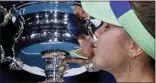 ?? LEE JIN-MAN — THE ASSOCIATED PRESS ?? Sofia Kenin of the U.S. kisses the Daphne Akhurst Memorial Cup after defeating Spain’s Garbine Muguruza in the women’s singles final at the Australian Open tennis championsh­ip in Melbourne, Australia, Saturday.