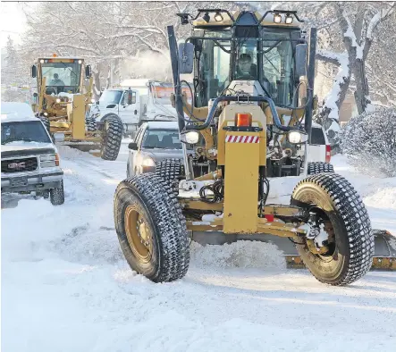  ?? GAVIN YOUNG ?? City of Calgary graders make their way around cars parked in the snow-ban area on 12th Avenue N.W. last week.