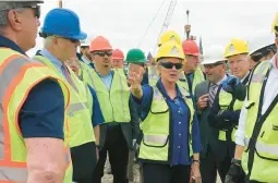  ?? JENNIFER MCDERMOTT/AP ?? U.S. Energy Secretary Jennifer Granholm tours the New London State Pier facility May 20 to view progress on a hub for the offshore wind power industry.