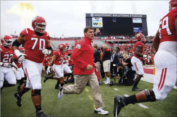  ?? THE ASSOCIATED PRESS ?? Rutgers head coach Chris Ash enters High Point Solutions Stadium with the team for the start of Saturday’s game against Iowa.