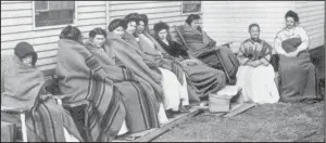  ??  ?? Above: Mary Mallon (pictured fourth from the right) spent more than one third of her life on North Brother Island.
Right: The island, as seen from above, is slowly being reclaimed by nature.