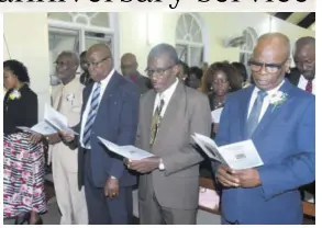  ??  ?? Custos of Kingston Steadman Fuller (right) and Iona High board member Rev Charles Danvers (second right) join the congregati­on in song.