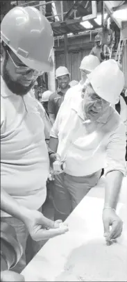  ?? ?? President Irfaan Ali (left) and Minister of Agricultur­e Zulfikar Mustapha examining some of the sugar produced at Rose Hall