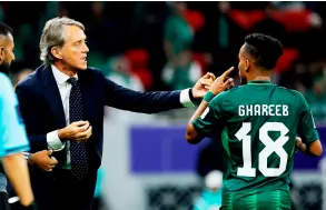  ?? — AFP photo ?? Mancini (left) speaks with his midfielder Abdulrahma­n Ghareeb during the Qatar AFC Asian Cup Group F match between Kyrgyzstan and Saudi Arabia at the Ahmad Bin Ali Stadium in Al-Rayyan, west of Doha.