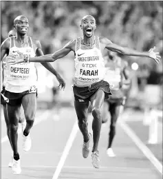  ?? — Reuters photo ?? Mo Farah of Britain reacts before crossing the finishing line during the men’s 10,000 metres race.