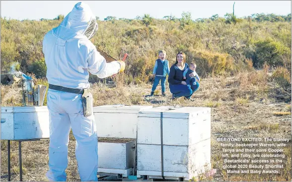  ??  ?? BEE-YOND EXCITED: The Stanley family, beekeeper Warren, wife Tanya and their sons Cooper, left, and Toby, are celebratin­g Beetanical­s’ success in the global 2020 Beauty Shortlist Mama and Baby Awards.