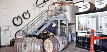  ?? AFP ?? An employee fills a whisky barrel in the Filling Store at the Glenturret Distillery.