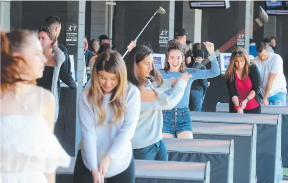  ?? Picture: RICHARD GOSLING ?? Brooklyn Daly, 16, and her family barely waited for their game at Topgolf yesterday but the venue’s popularity regularly causes long delays.