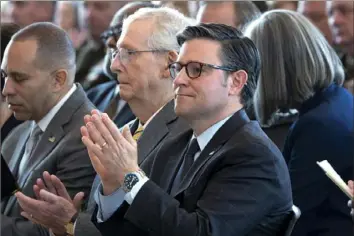  ?? J. Scott Applewhite/Associated Press ?? Speaker of the House Mike Johnson, R-La., from right, and Senate Minority Leader Mitch McConnell, R-Ky., applaud Wednesday during a Congressio­nal Gold Medal ceremony. Mr. Johnson said that after the spending package passes, the House would next turn its attention to a bill that focuses on aiding Ukraine and Israel.