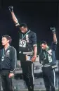  ?? ASSOCIATED PRESS FILE PHOTO ?? Americans Tommie Smith, center, and John Carlos extend gloved hands skyward in protest at the 1968Mexico City Olympics.