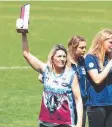  ??  ?? TALENTED: Judy McCarthy holds Amy Gorell’s best-andfairest trophy at her funeral.