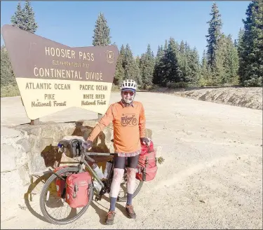  ?? (Courtesy Photo) ?? Jim Klinger of Bella Vista is pictured at Hoosier Pass, the point of highest elevation on his journey across the TransAmeri­ca Trail.