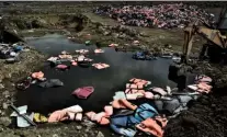  ??  ?? Left: Syrian migrants prepare to make the treacherou­s crossing from Turkey to Lesbos. Above: piles of abandoned life jackets show just how many people are making the desperate journey