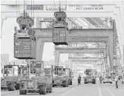  ?? Patrick Semansky / Associated Press file ?? Containers are unloaded at the Port of Baltimore.