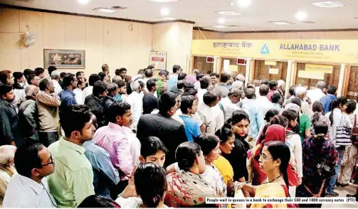  ??  ?? People wait in queues in a bank to exchange their 500 and 1000 currency notes (PTI)