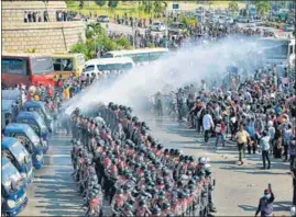  ??  ?? Police use water cannon against protesters in Naypyidaw.