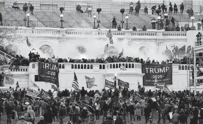  ?? Associated Press file photos ?? Rioters storm the Capitol on Jan. 6 in Washington. New details from the riot are contained in a previously undisclose­d document prepared by the Pentagon for internal use and vetted by government officials.
