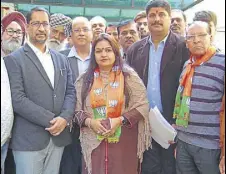  ?? HT ?? Former minister Anil Joshi ((left) with BJP candidate Preeti Taneja after she filed her papers in Amritsar on Wednesday.