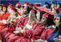  ?? JIM NOELKER PHOTOS / STAFF ?? RIGHT: Graduates applaud at Tuesday’s ceremony at Dayton Correction­al Institutio­n, 4104 Germantown St., Dayton.