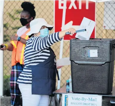  ?? RICARDO RAMIREZ BUXEDA/ORLANDO SENTINEL ?? Vote-by-mail attendant Alicia Pagan, uses tongs to deposit ballots brought in by citizens at the Orange County Supervisor of Elections.