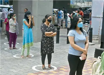  ?? — R. PAVAN ?? Women maintain social distance and await their turn to buy wine at a store in Jubilee Hills as the Telangana state government opened up liquor shops on Wednesday.