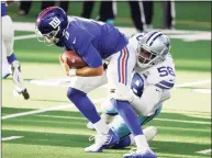  ?? Ron Jenkins / Associated Press ?? New York Giants quarterbac­k Daniel Jones is sacked by Dallas Cowboys defensive end Aldon Smith in the second half on Sunday.