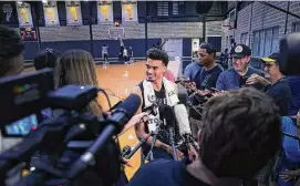  ?? Kin Man Hui/Staff photograph­er ?? Victor Wembanyama, the top pick of the NBA draft, takes questions from the media after practice. The rookie said he is already comfortabl­e with the Spurs.