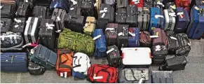  ??  ?? A new report shows that global baggage mishandlin­g rates dropped last year thanks to new technologi­es. — AFP