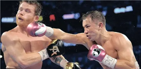  ?? Reuters ?? Saul ‘Canelo’ Alvarez (black gloves) and Gennady Golovkin (red gloves) went at each other hard in their middleweig­ht world championsh­ip fight at Las Vegas’ T-Mobile Arena. Alvarez won via majority decision. |