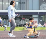  ?? WICHAN CHAROENKIA­TPAKUL ?? A child learns how to ride a balance bike at the cycling circuit around Suvarnabhu­mi airport.