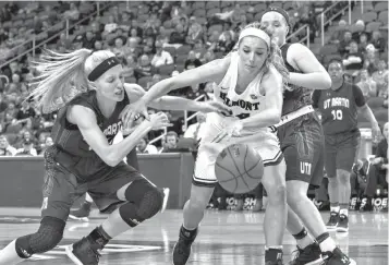  ?? Associated Press ?? ■ Belmont's Jenny Roy (24) fights for the ball with UT Martin's Maddie Waldrop, left, during the first half of an NCAA college basketball game in the championsh­ip of the Ohio Valley Conference tournament Saturday in Evansville, Ind.