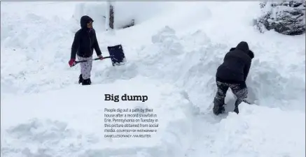  ?? COURTESY OF INSTAGRAM @ DANIELLESO­FANCY /VIA REUTER ?? People dig out a path by their house after a record snowfall in Erie, Pennsylvan­ia on Tuesday in this picture obtained from social media.