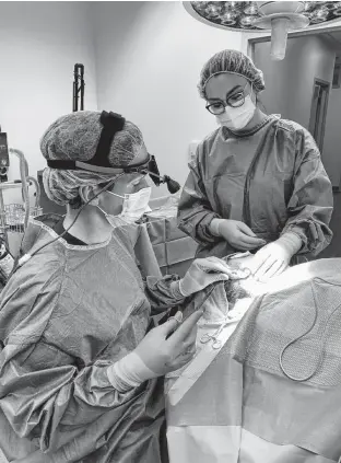  ?? CONTRIBUTE­D ?? Registered nurse Julia Macdonald assists during a surgery. When she finishes her nurse practition­er program, she could work in any number of health-care fields.