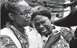  ?? SIMON MAINA/GETTY-AFP ?? A woman cries after identifyin­g the body of a relative Wednesday in Nairobi, Kenya, after a blast followed by a gun battle rocked a hotel and shopping complex.