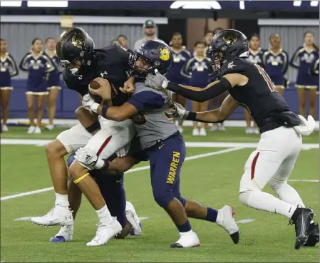  ?? PHOTO BY TRACEY ROMAN ?? Warren’s Julian Garcia, middle, tries to stop Downey’s Oscar Rios during the Bears’ victory over the rival Vikings last Friday at SoFi Stadium.