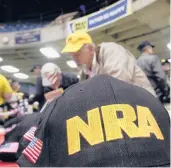  ?? SETH PERLMAN/AP 2012 ?? Gun owners and supporters file NRA applicatio­ns during a convention before marching to the Illinois State Capitol in Springfiel­d, Illinois.