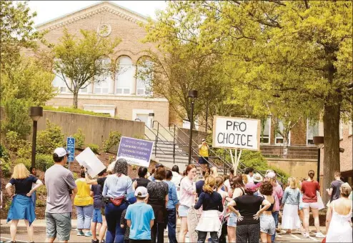  ?? Patrick Sikes / For Hearst Connecticu­t Media ?? Three Darien High School seniors organized a march on Saturday in town to support abortion rights.